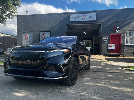 Luxury vehicle parked in front of Metro Motor auto body shop and collision repair center