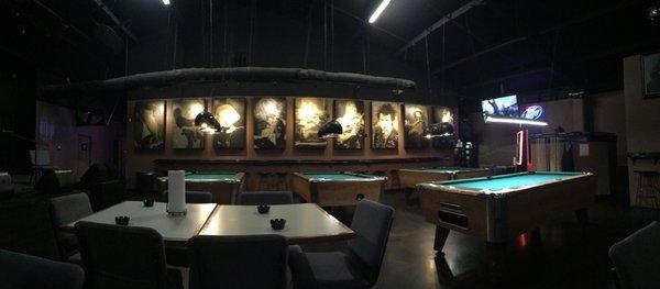 Pool tables and sturdy bar on the wall for leaning on after that last drink.