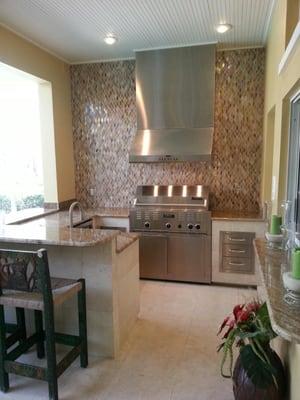 Custom outdoor kitchen with glass tile back splash
