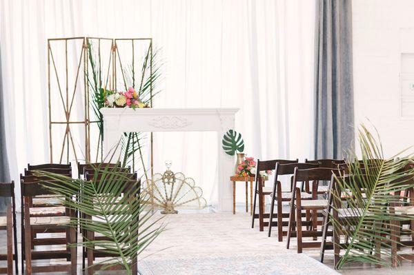 A tropical boho inspired ceremony backdrop with our Marisol Mantel, Bali Screen and vintage brass fireplace screen at The Doyle