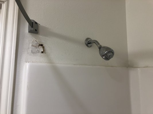 Holes in walls and dirty shower.