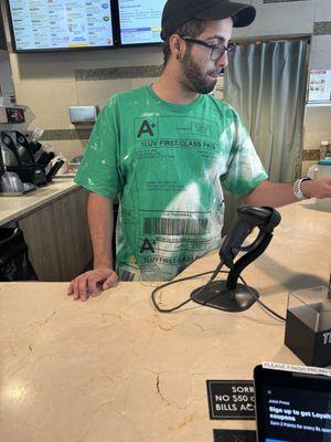 This guy at the smoothie desk wearing a love shirt could not care less about helping people