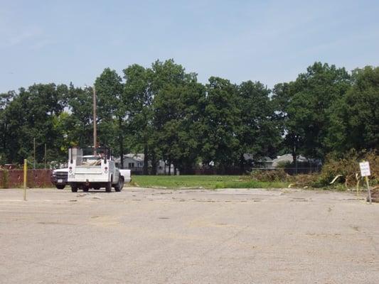 The old parking lot with a limited view of the old playground.