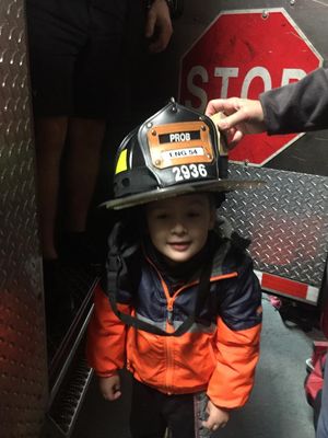 Gavin trying on Fireman Pat's helmet.