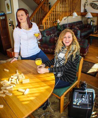 Happy customers enjoying oxygen therapy with mimosas and jenga.