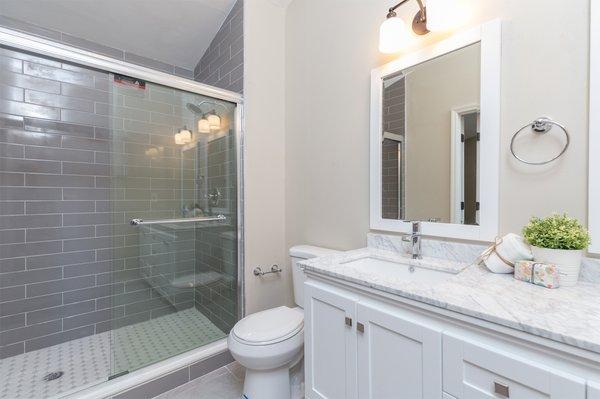 Remodeled bathroom with new shower tile and new vanity and paint.