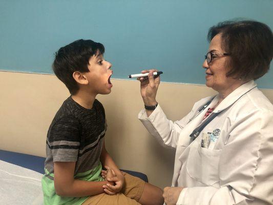 Doctor Norma B. Cornejo examining a young patient.