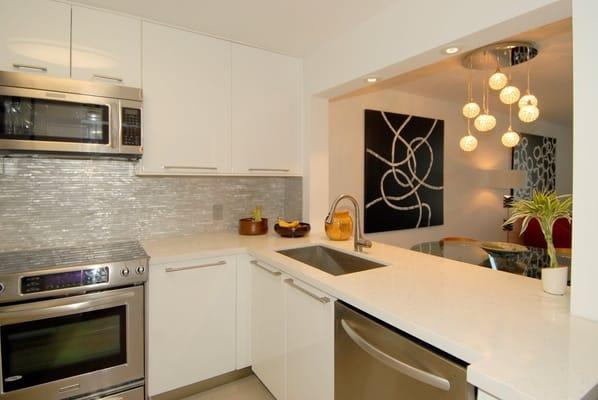 JOES KITCHEN - LACQUER WHITE DOORS - QUARTZ COUNTER TOPS - 
SQ STAINLESS SINK - FAUCET - BY BATH TRENDS.