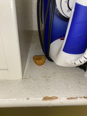 Chicken nugget on the shelf with a bite out of it