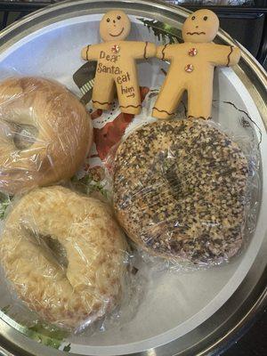 Bagels with tiny gingerbread people that survived the holidays despite the message on them.