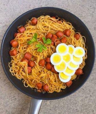 Spaghetti with hot dog and boiled eggs