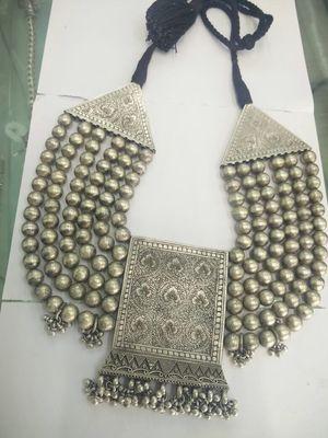 This is a traditional Indian design with six lines and a center pendant it's pure silver and makes a great neckpiece