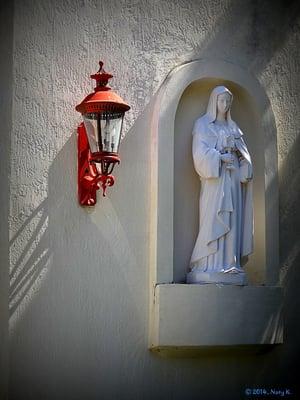 Sculpture of Saint Clare on the wall.