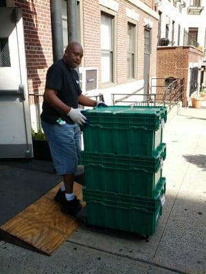 Joseph, a Storage Bucket Happiness Agent, delivering some bins to a customer.