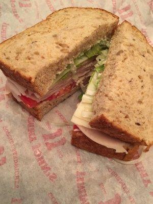 Turkey Tom on 9 grain whole wheat bread, light lettuce and tomatoes, add avocado spread and onions.