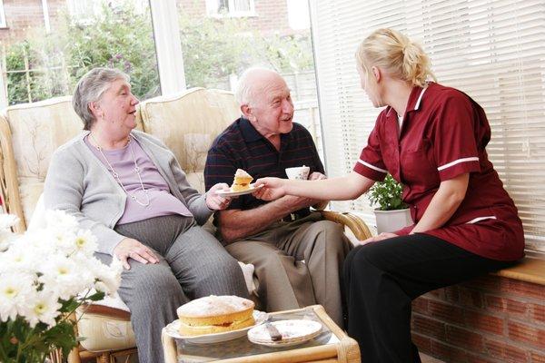 Seniors happily receiving care at home.