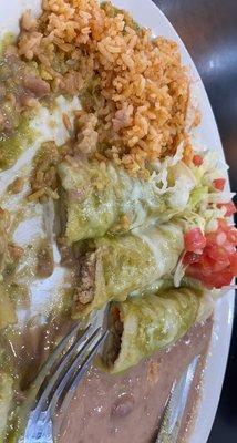 One beef, one cheese, one chicken enchilada with verde sauce & rice & beans.