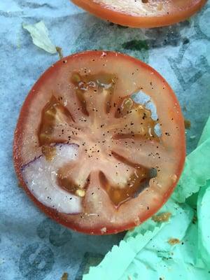 Picture of not yet ripe tomato. You can see how white the core is in contrast to the skin. All were like this. Very acidic.