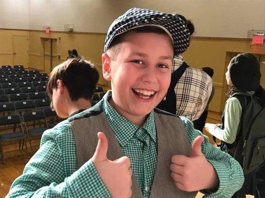 Happy Camper Kieran sporting a paper boy costume.