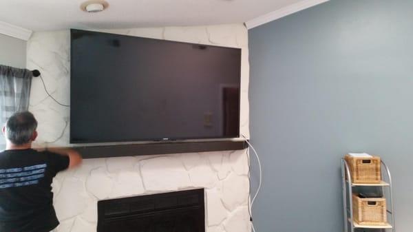 70" Sony 4k above fireplace on stone.