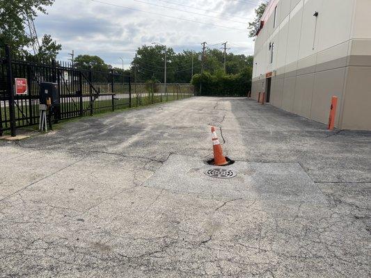 Potholes keep getting bigger and this is their facility maintenance in the path to get to the building door.