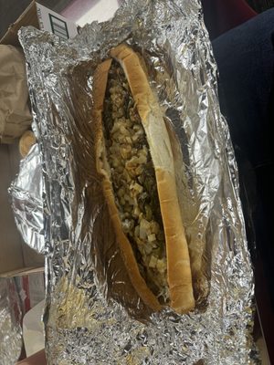 Large cheese steak with peppers onions and provolone. Added some hot sauce.