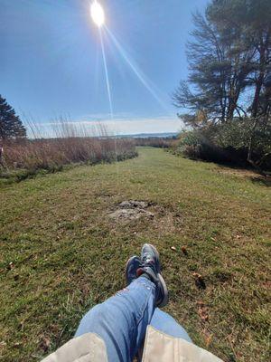 Relaxing on a bench, enjoying the view of the prairie and Lake Mendota in the distance.