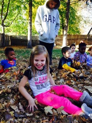 playing in a pile of leaves