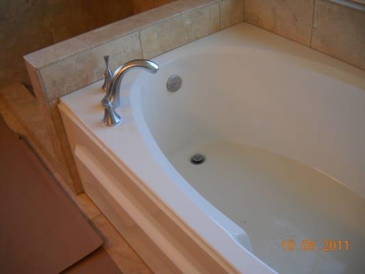 New tile and new faucet make old tub look new again.