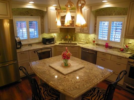 Beautiful granite counter tops and granite back splash going all the way to the ceiling