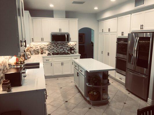 Quartz counters and tile backsplash by Marble and Granite Imports.