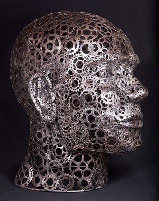 welded metal bust sculpture made from used bicycle sprockets. aprox 30" H. x 24"W.