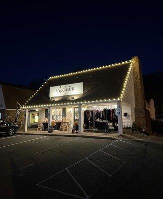 Exterior view from the left side at dusk; featuring seasonal Christmas lights.