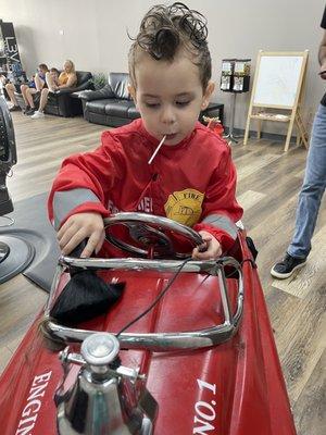 Getting his haircut and helping clean up!