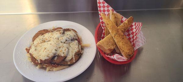 Eggplant Parmesan over Penne Pasta served with garlic bread.