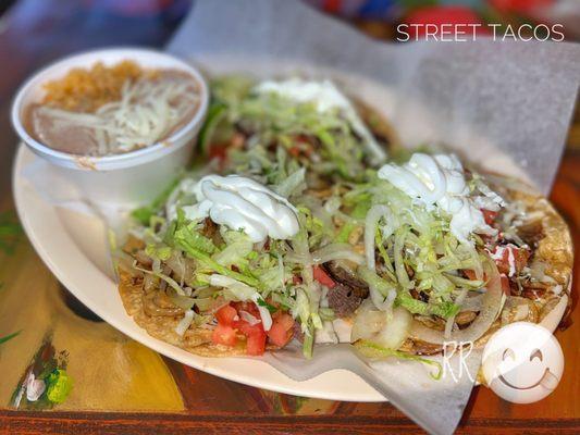 Lengua, shredded beef & carnitas tacos with upcharge for lettuce, tomatoes, sour cream & grilled onions (w/rice & beans)