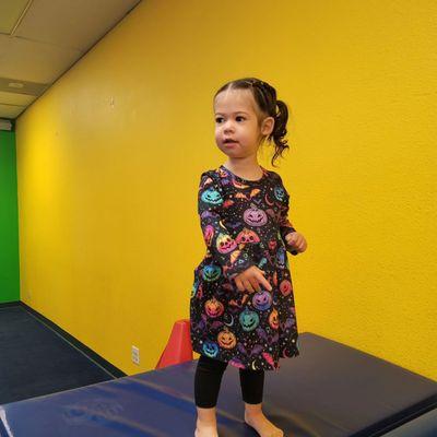 Oldest daughter about to jump in the ball pit.