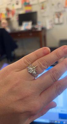 Engagement ring set with a diamond & polished to a sparkling white at Goldstein's.