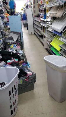 Looks like a hoarders house. All the aisles are lined with stuff needing to be put away. Employees are just standing around