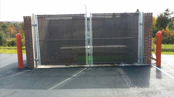 Double drive gates on dumpster enclosure