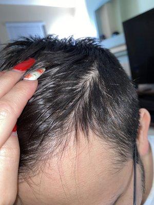 She tried putting a hard part in his hair which he did not ask for. But it was very uneven as you can see in the picture