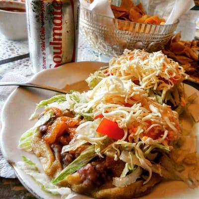 Sopes be Maza Dough round Deep Fried n topped with beans and choice of meat Chichirones then Queso Cheese n Maters