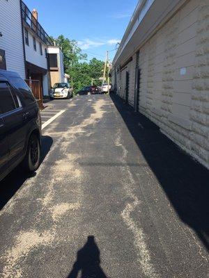 This drive through alley way gets very little traffic. Look at this mess. Only 6 months after he sealed it.