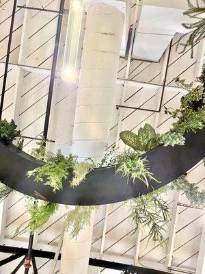 Looking up at the suspended circular plant stand.