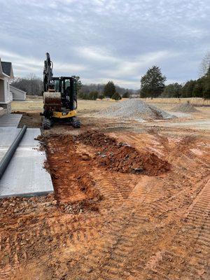 Installing a culvert to help with drainage on a new construction