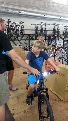 John Mueller, owner, helping my son find the right bike