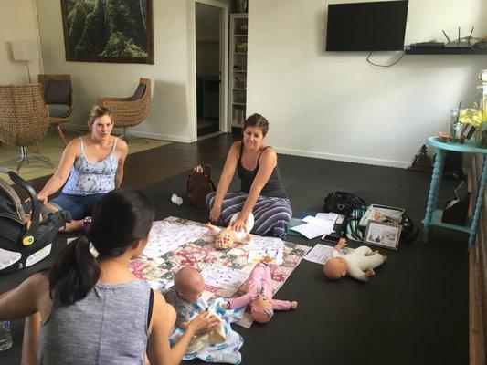 Our infant massage instructor, Tracy, with two moms and babies during an infant massage class in Honolulu.