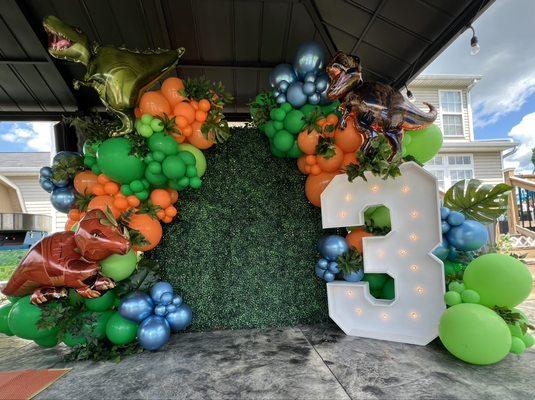 Boxwood Hedge Greenery Wall, marquee light up numbers, organic balloon garland