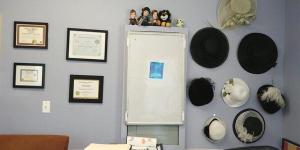 Another office wall. To the right is the wall of hats.