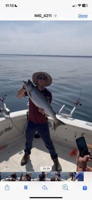 Frank is in this photo holding a 20 pound Salmon. Team effort to reel it in